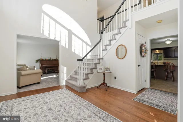 a living room with fireplace furniture and a rug