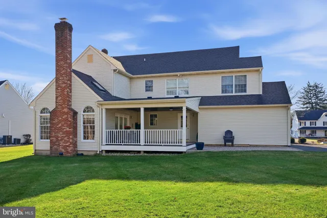 a front view of a house with a garden and yard