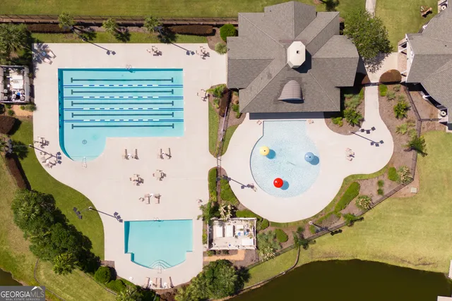 a view of a house with a big yard and large trees