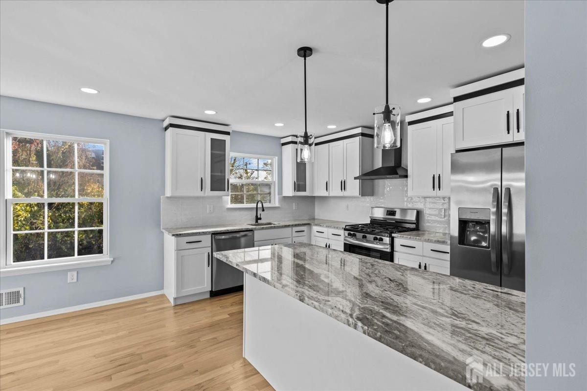 104 Maple Place Keyport, NJ 07735 - Photo 11 of 67 a large kitchen with stainless steel appliances granite countertop a stove a sink a refrigerator and a granite counter tops