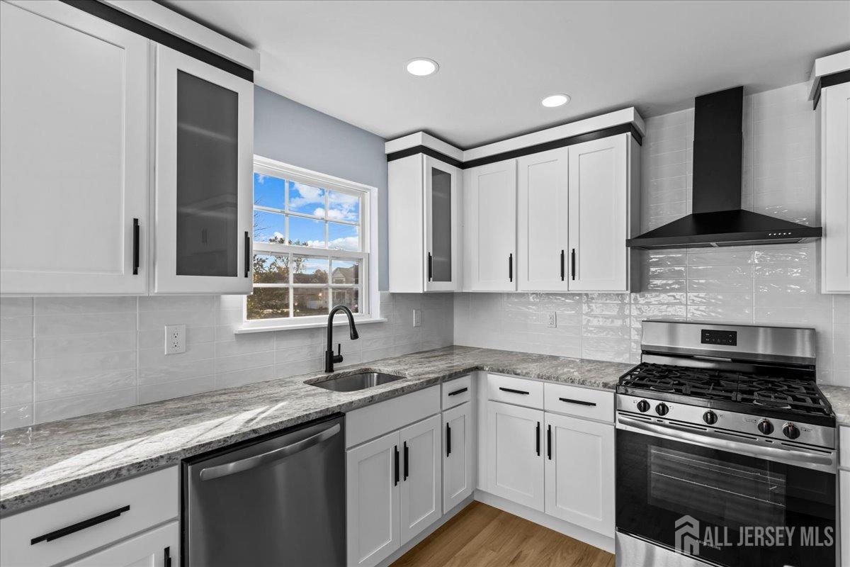 104 Maple Place Keyport, NJ 07735 - Photo 14 of 67 a kitchen with stainless steel appliances granite countertop a sink a stove and a microwave