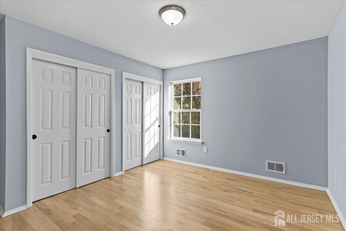 104 Maple Place Keyport, NJ 07735 - Photo 23 of 67 wooden floor in an empty room with a window