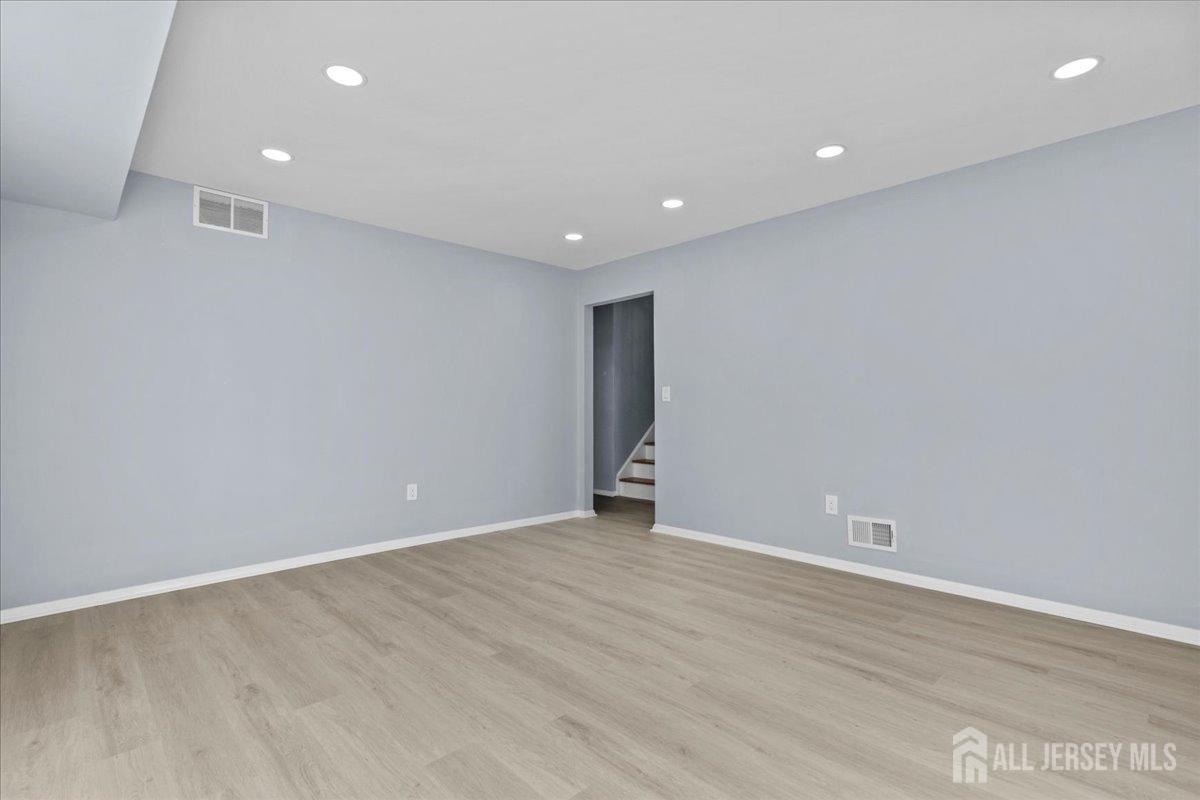 104 Maple Place Keyport, NJ 07735 - Photo 34 of 67 a view of an empty room with wooden floor