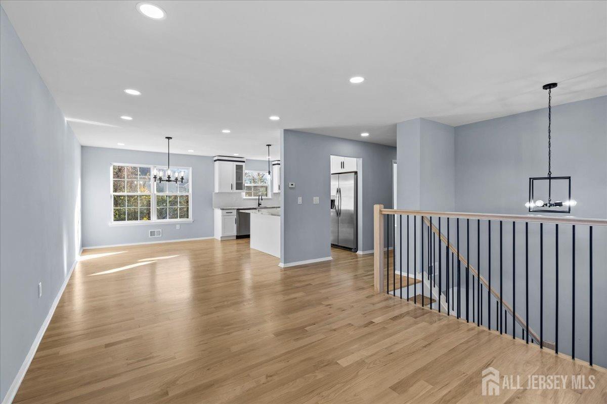 104 Maple Place Keyport, NJ 07735 - Photo 8 of 67 a view of an empty room with a window and wooden floor