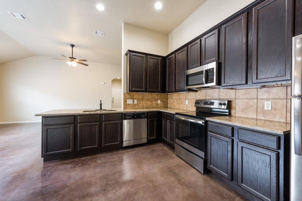 491 Jack Rabbit Lane, Unit A Buda, TX 78610 - Photo 5 of 22 A pristine culinary space awaits, featuring ample cabinetry and essential appliances for effortless meal preparation.