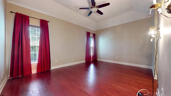 a view of a room with wooden floor and windows