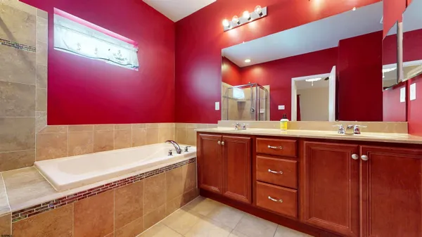 a bathroom with a sink a large mirror and a bathtub