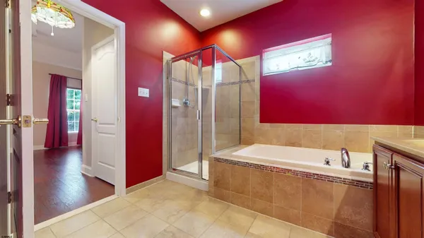 a bathroom with a bathtub and a shower