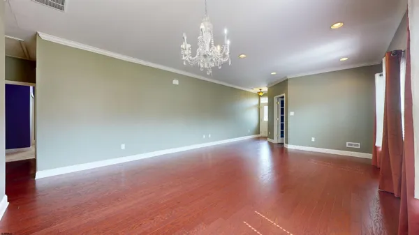 a view of livingroom with hallway and wooden floor