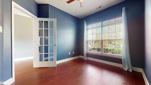a view of wooden floor and windows in a room