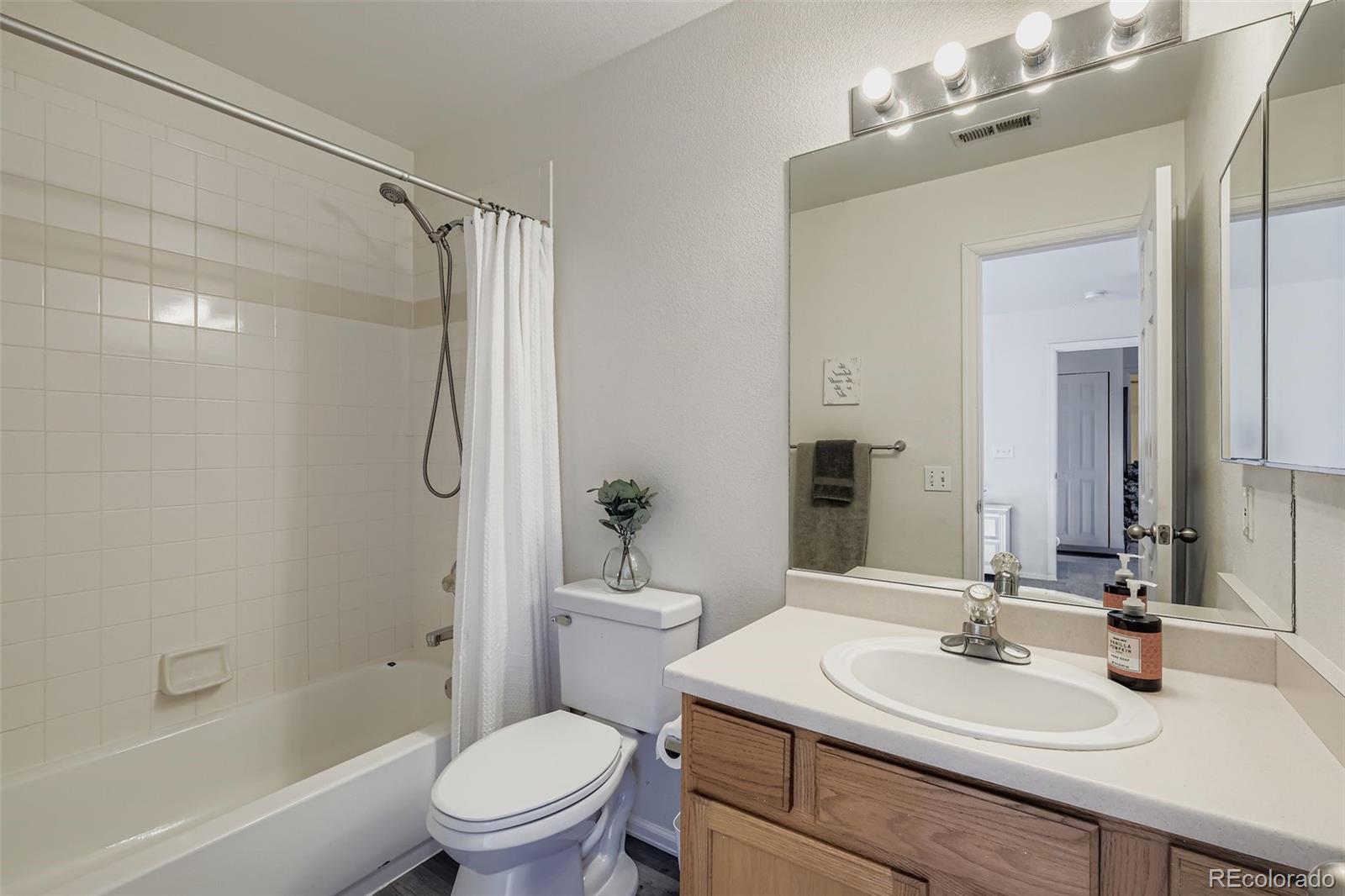 283 Ellers Grove Colorado Springs, CO 80916 - Photo 12 of 17 a bathroom with a sink toilet tub and shower