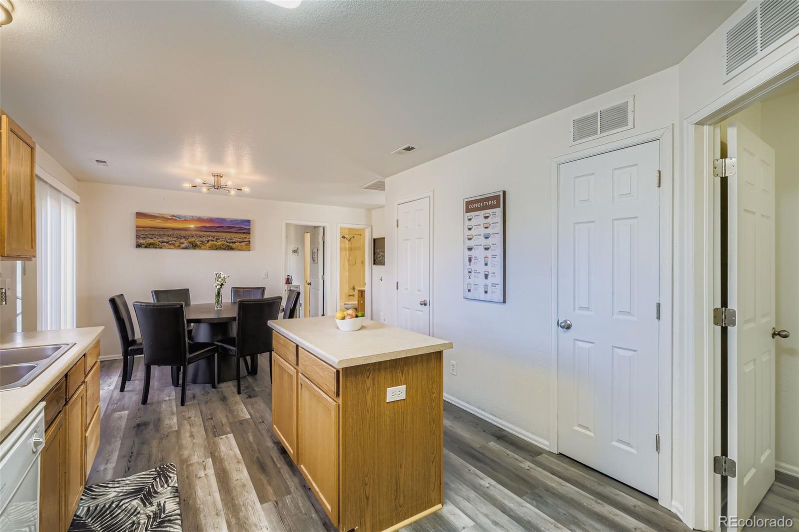 283 Ellers Grove Colorado Springs, CO 80916 - Photo 8 of 17 a view of a dining room with furniture window and wooden floor