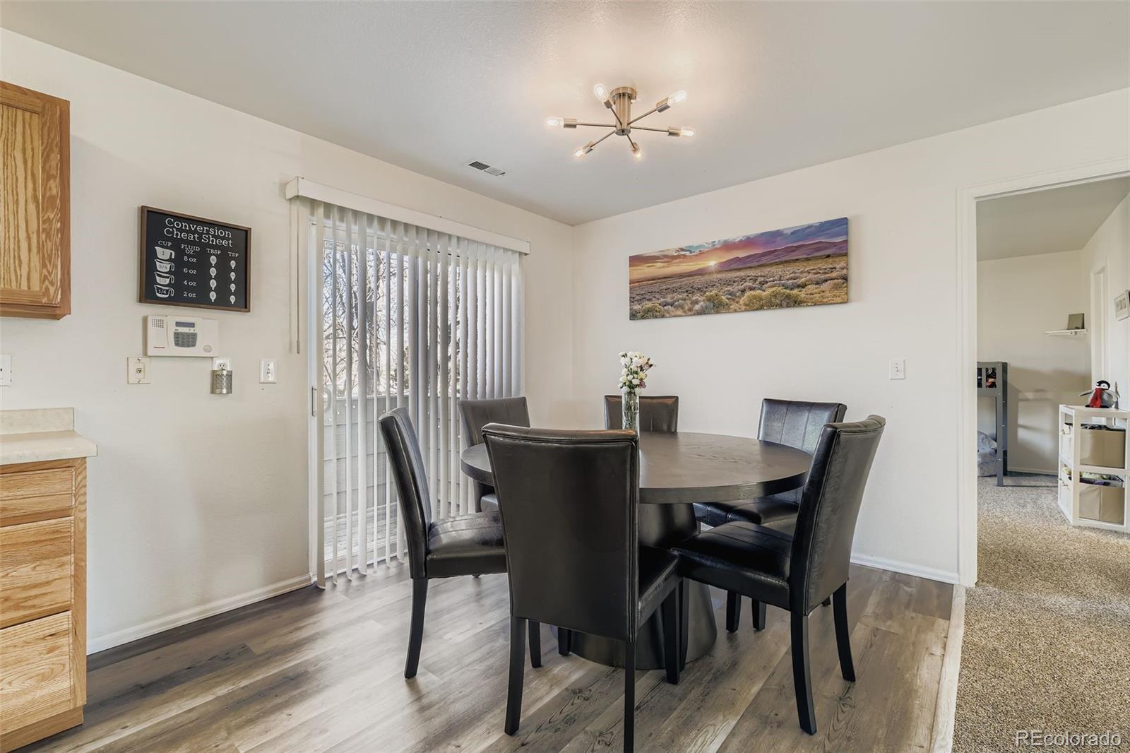 283 Ellers Grove Colorado Springs, CO 80916 - Photo 9 of 17 a view of a dining room with furniture and wooden floor