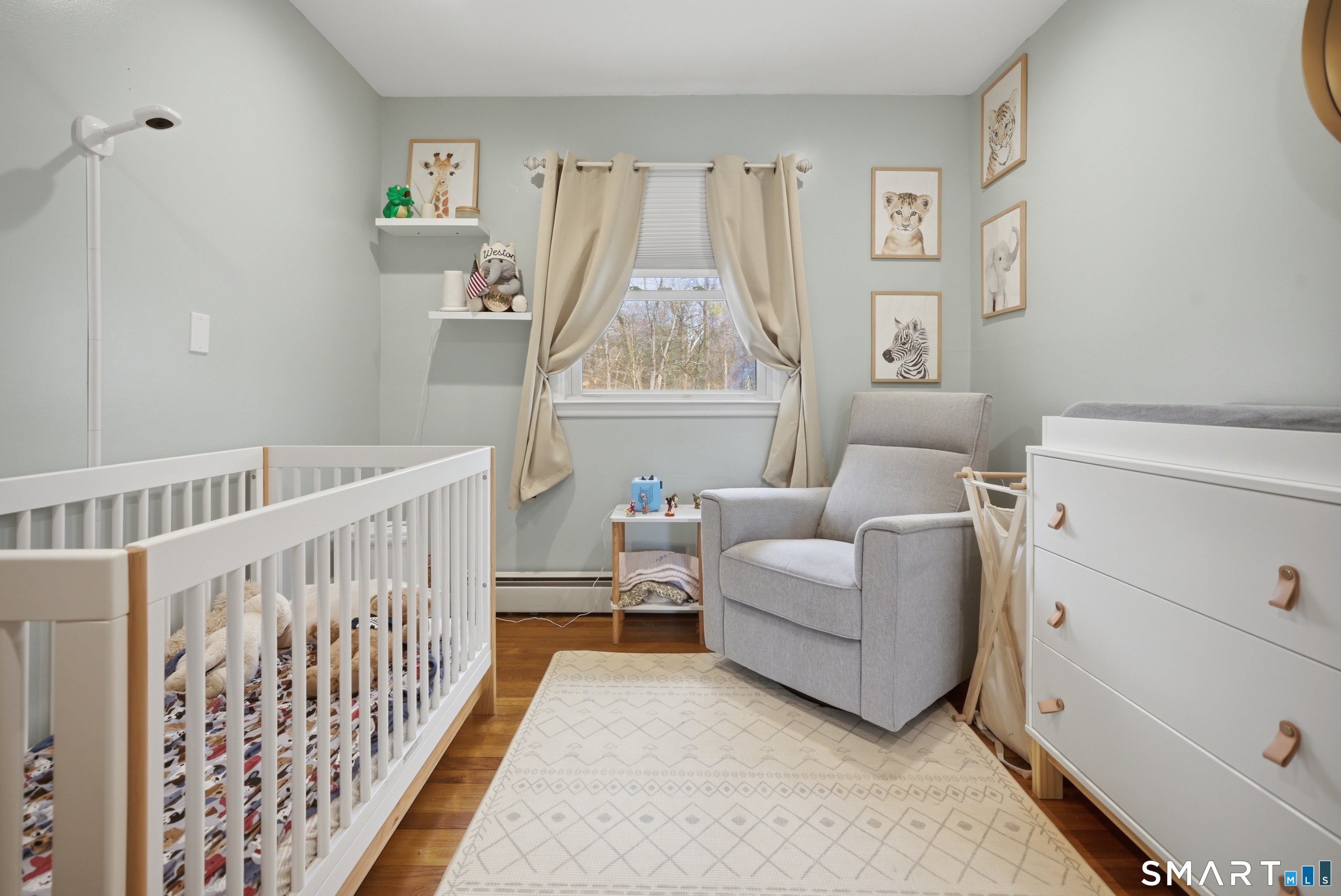 96 Toll House Lane Fairfield, CT 06825 - Photo 11 of 29 a living room with furniture and a baby crib