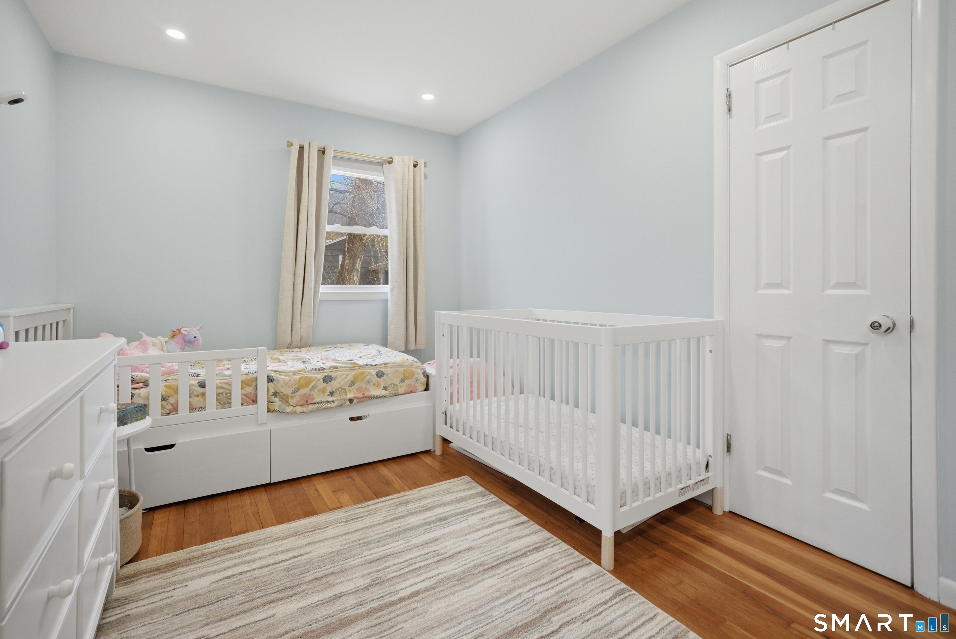 96 Toll House Lane Fairfield, CT 06825 - Photo 14 of 29 a view of a bedroom with wooden floor & a ceiling fan