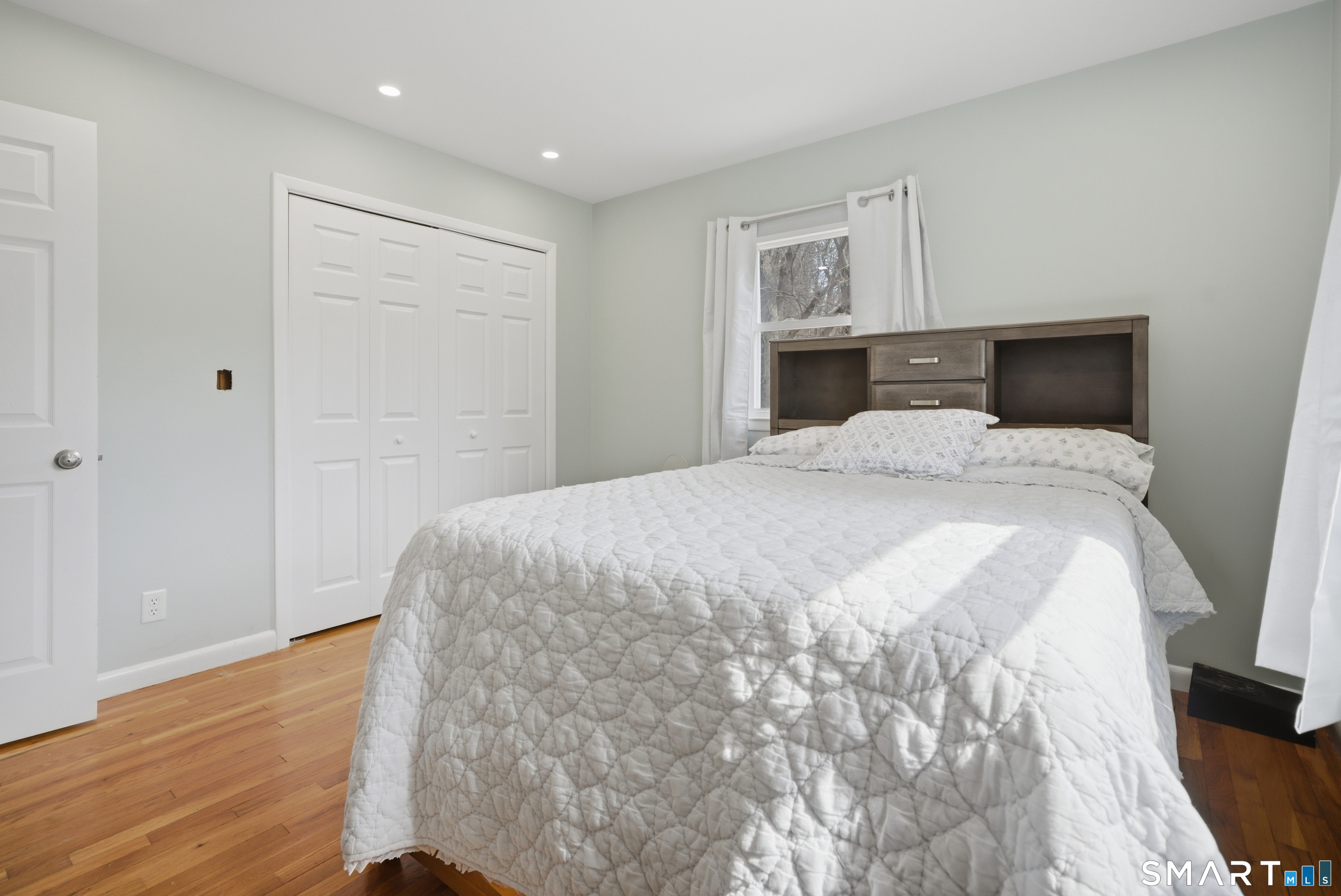 96 Toll House Lane Fairfield, CT 06825 - Photo 15 of 29 a spacious bedroom with a bed and wooden floor