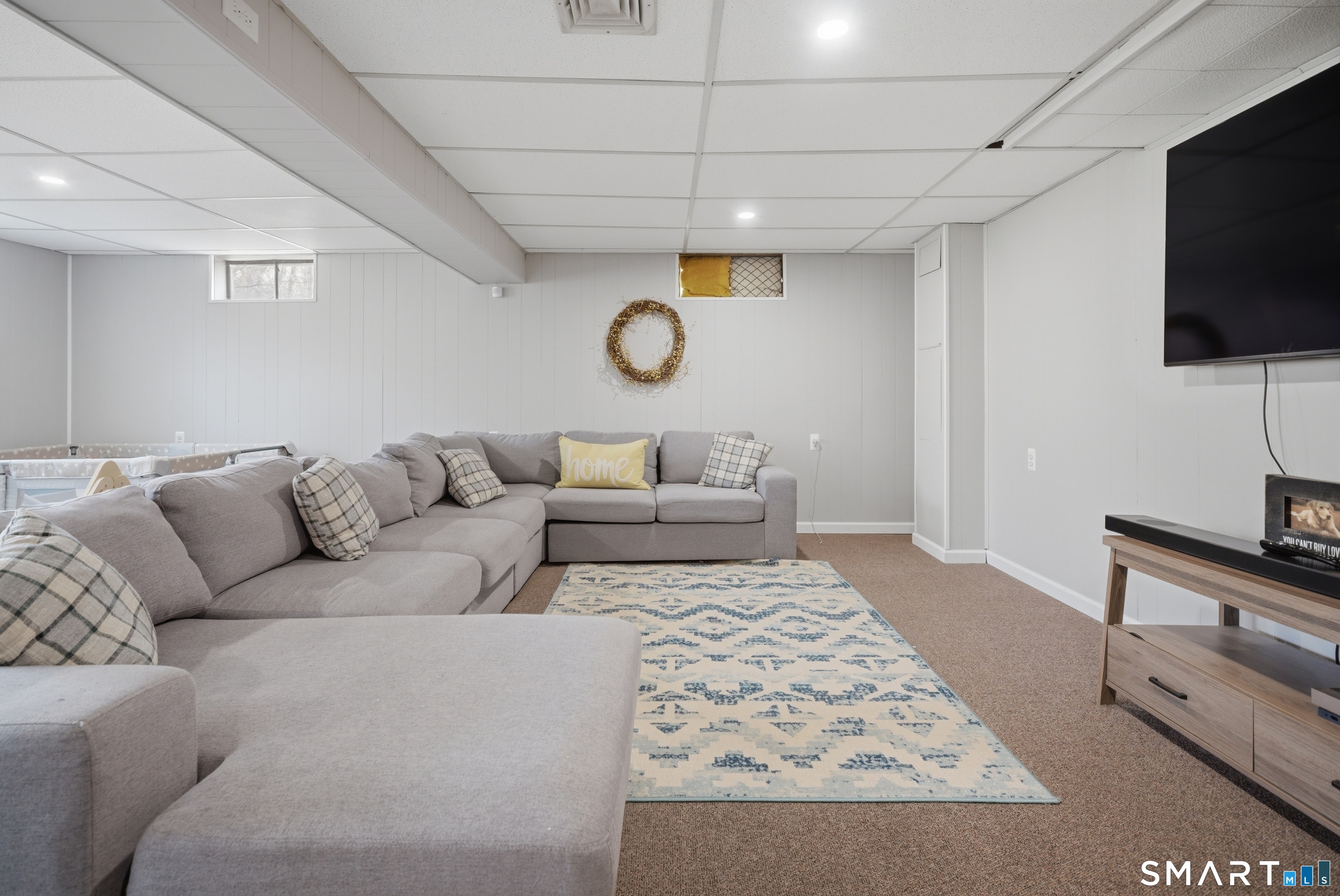 96 Toll House Lane Fairfield, CT 06825 - Photo 17 of 29 a living room with furniture and a flat screen tv