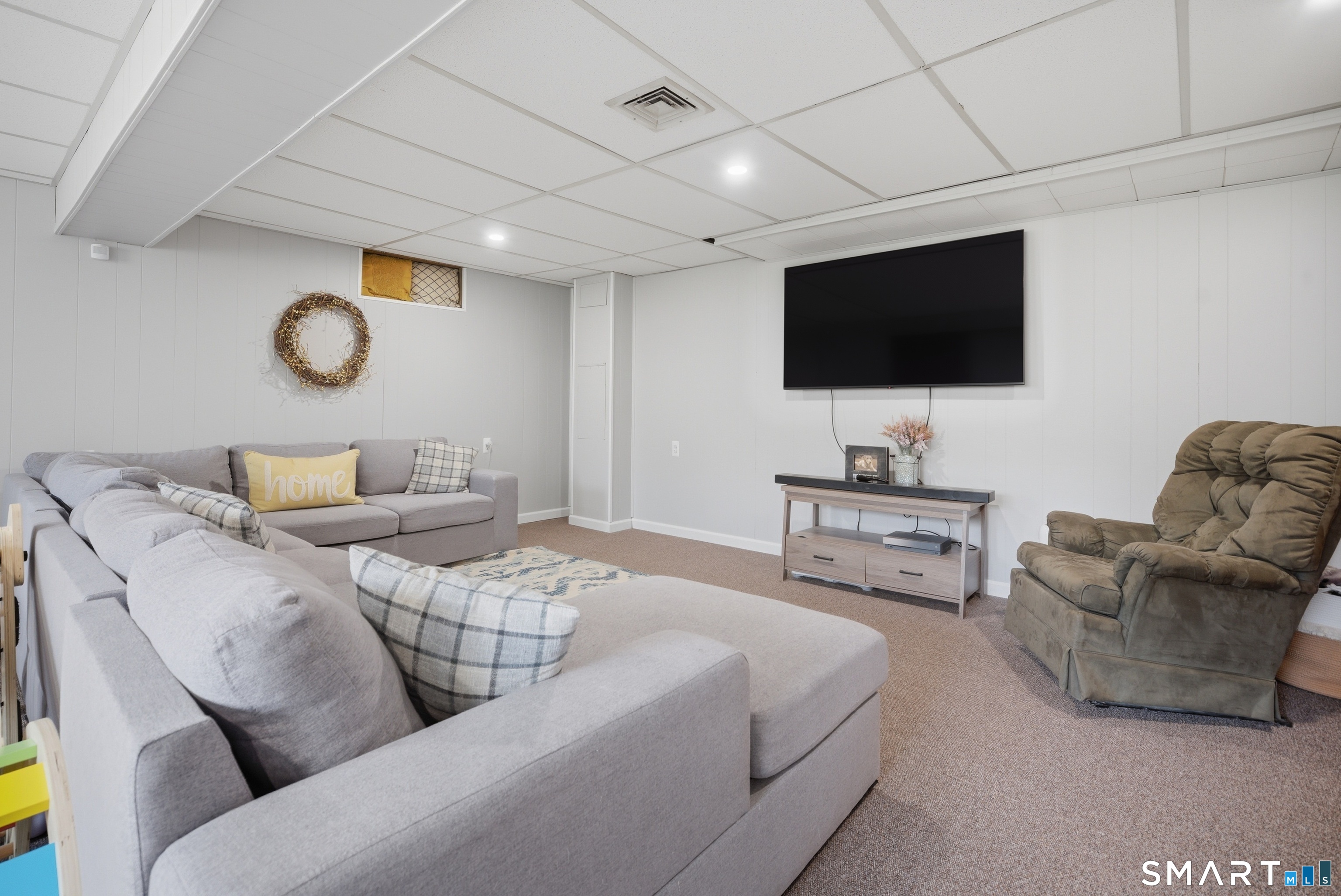 96 Toll House Lane Fairfield, CT 06825 - Photo 19 of 29 a living room with furniture and a flat screen tv