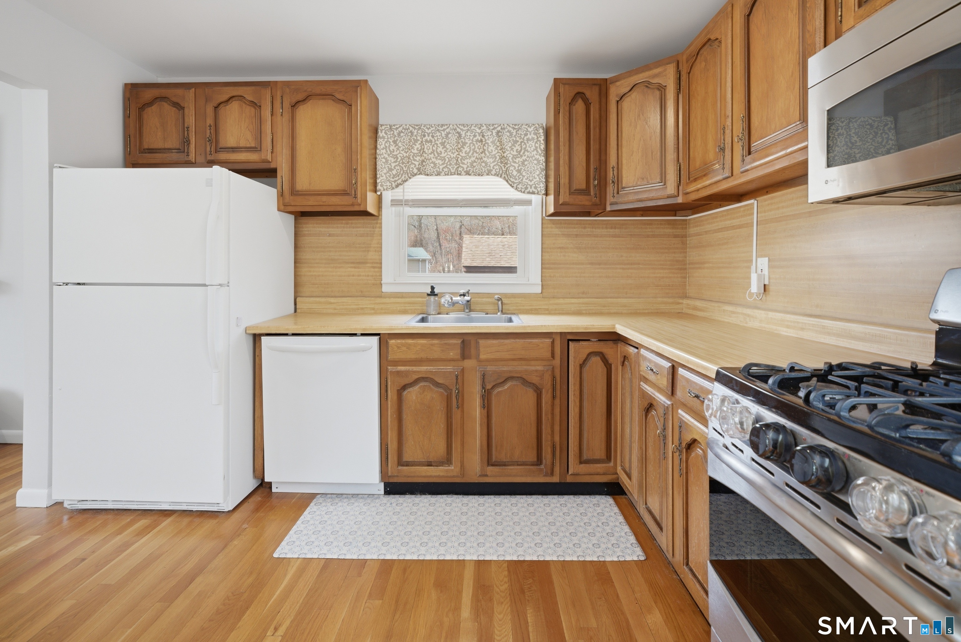 96 Toll House Lane Fairfield, CT 06825 - Photo 9 of 29 a kitchen with a sink a stove and cabinets