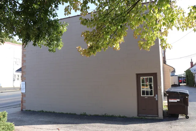 a view of a house with a tree