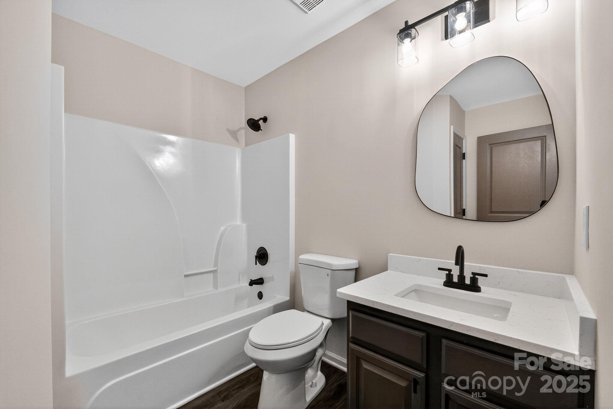 11227 Suunto Lane Cornelius, NC 28031 - Photo 15 of 20 a bathroom with a sink a toilet and a mirror