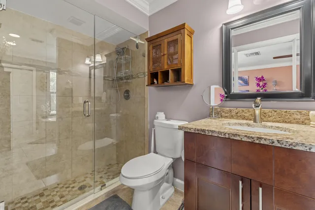 a bathroom with a granite countertop sink toilet and shower