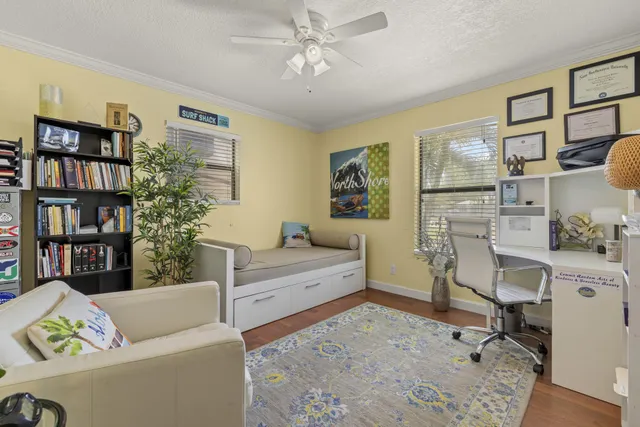 a living room with furniture and a book shelf