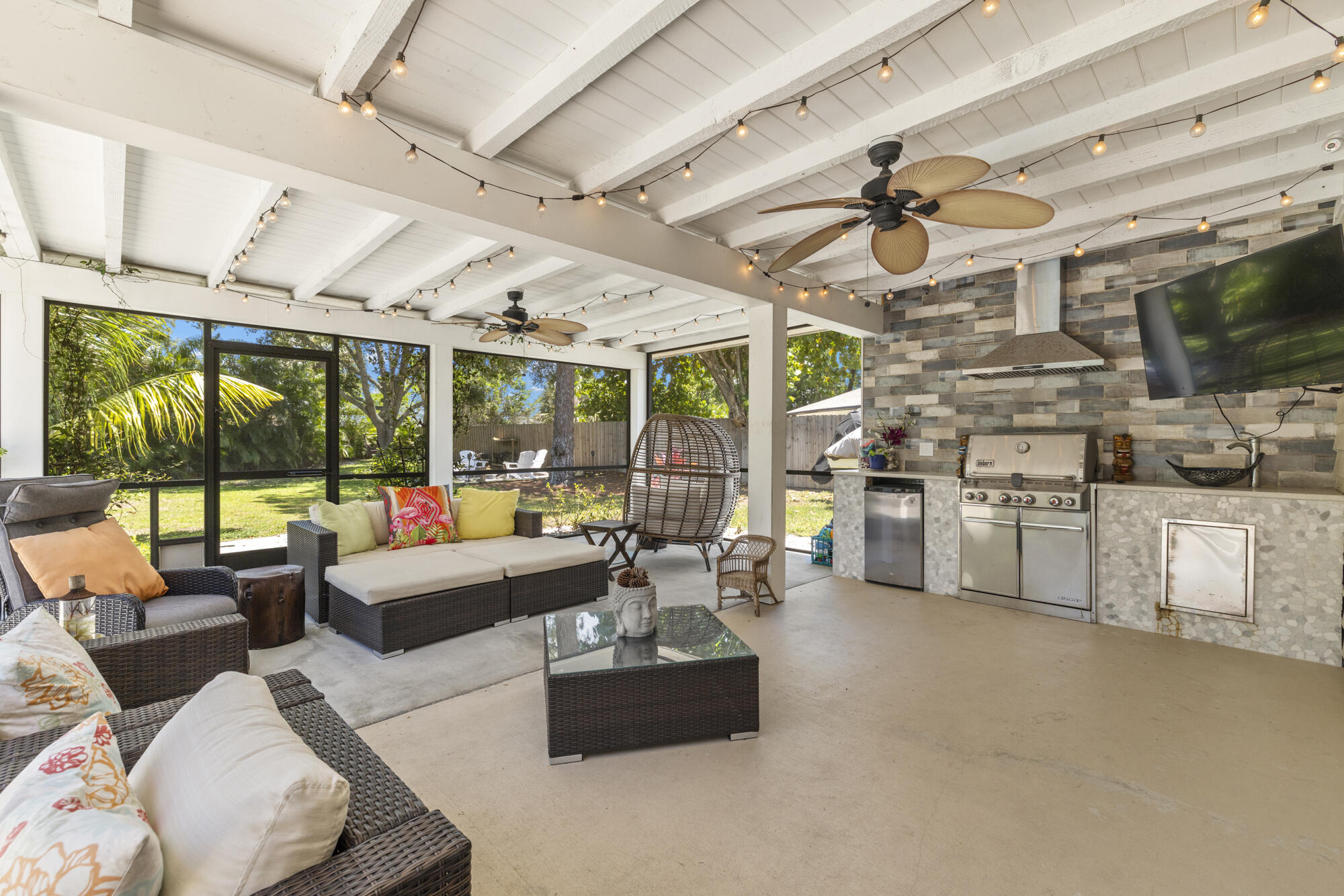 591 Kriss Lane Jupiter, FL 33458 - Photo 22 of 36 a living room with furniture and a flat screen tv