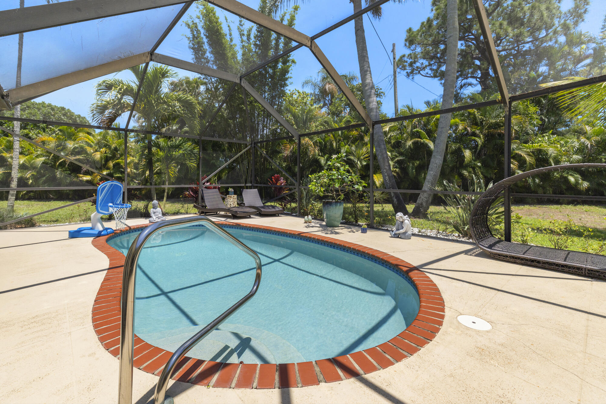 591 Kriss Lane Jupiter, FL 33458 - Photo 25 of 36 a view of a swimming pool with a patio
