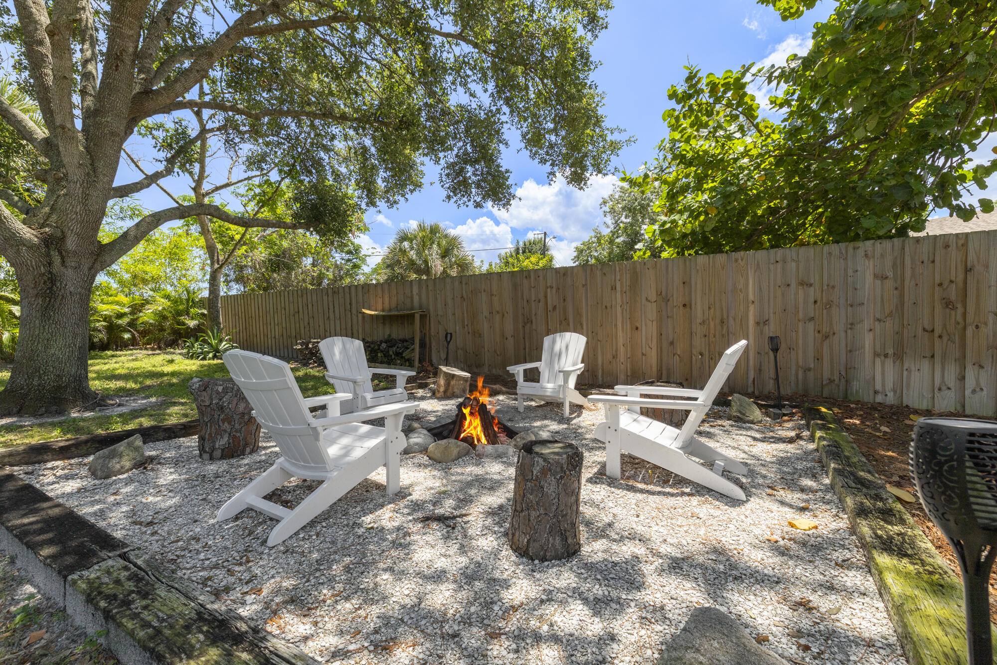 591 Kriss Lane Jupiter, FL 33458 - Photo 27 of 36 a view of a outdoor space with a patio and fire pit