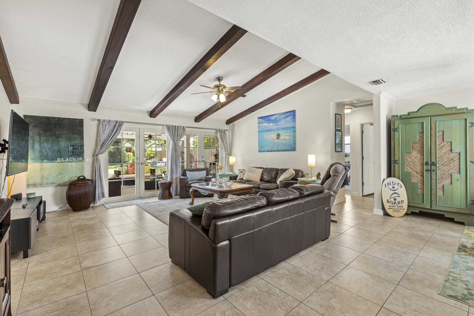 591 Kriss Lane Jupiter, FL 33458 - Photo 6 of 36 a living room with furniture a large window and potted plants