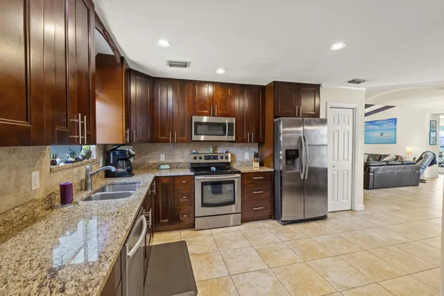 a large kitchen with cabinets and stainless steel appliances
