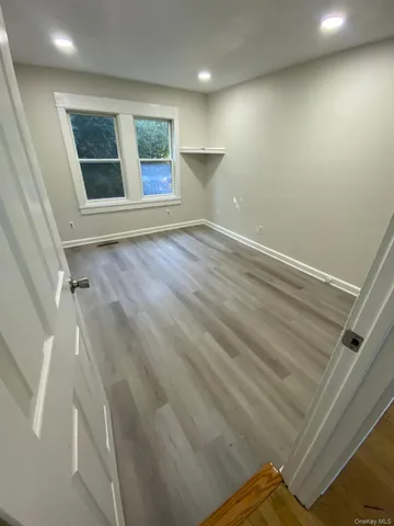 an empty room with windows and closet
