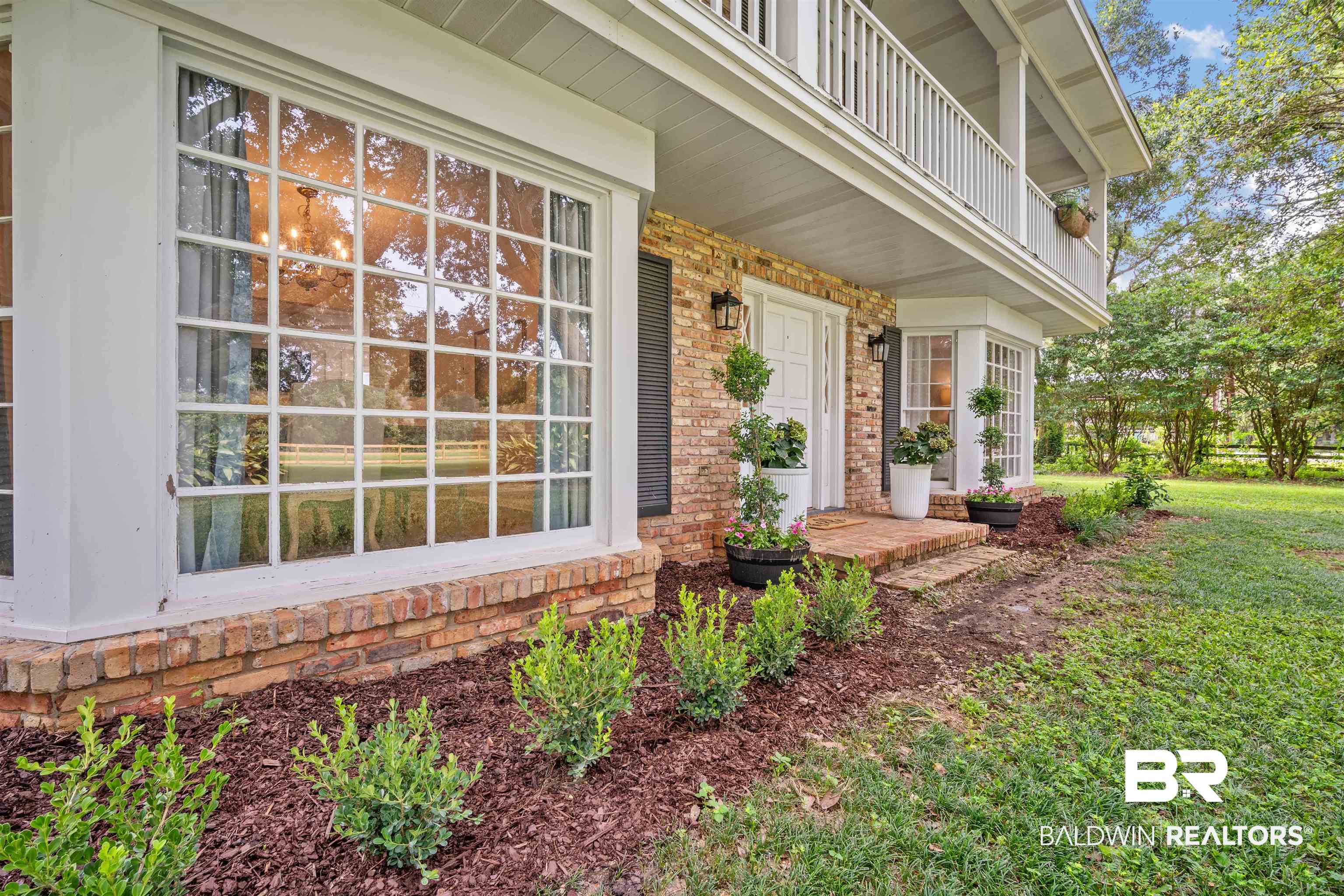 700 Eliza Jordan Road North Mobile, AL 36608 - Photo 9 of 44 Entrance to property with brick siding, a porch, and a balcony
