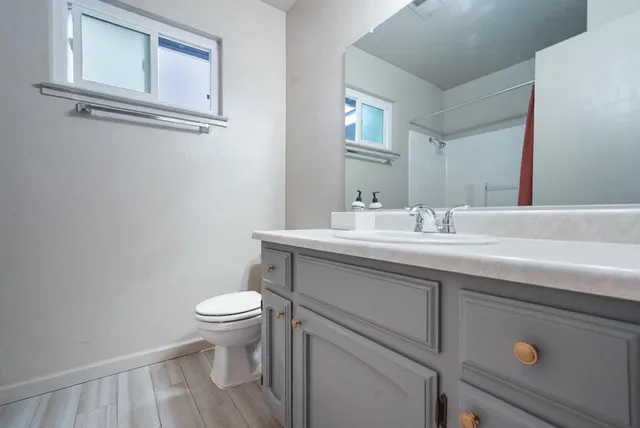 a white toilet sitting next to a bath tub