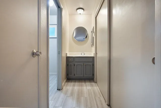 a bathroom with a sink a toilet and a mirror