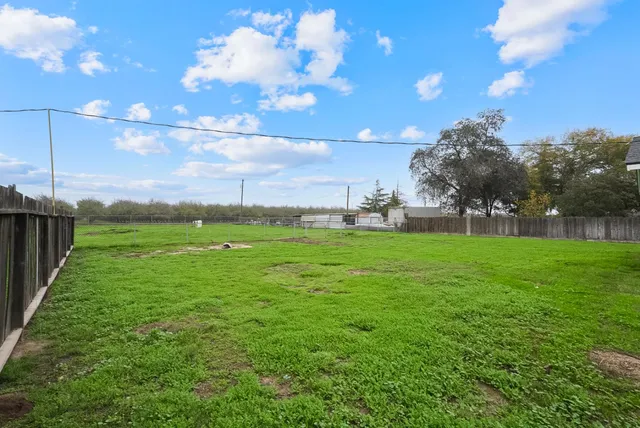 a backyard of a house with lots of green space