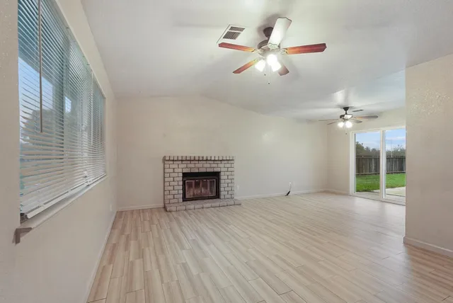 wooden floor in an empty room with a fireplace