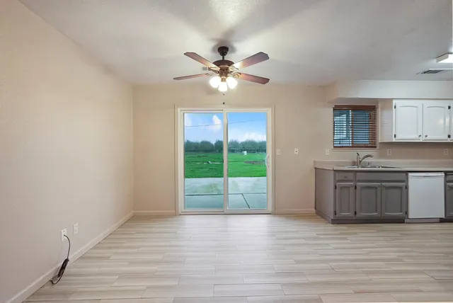 a view of a kitchen with a sink and a window