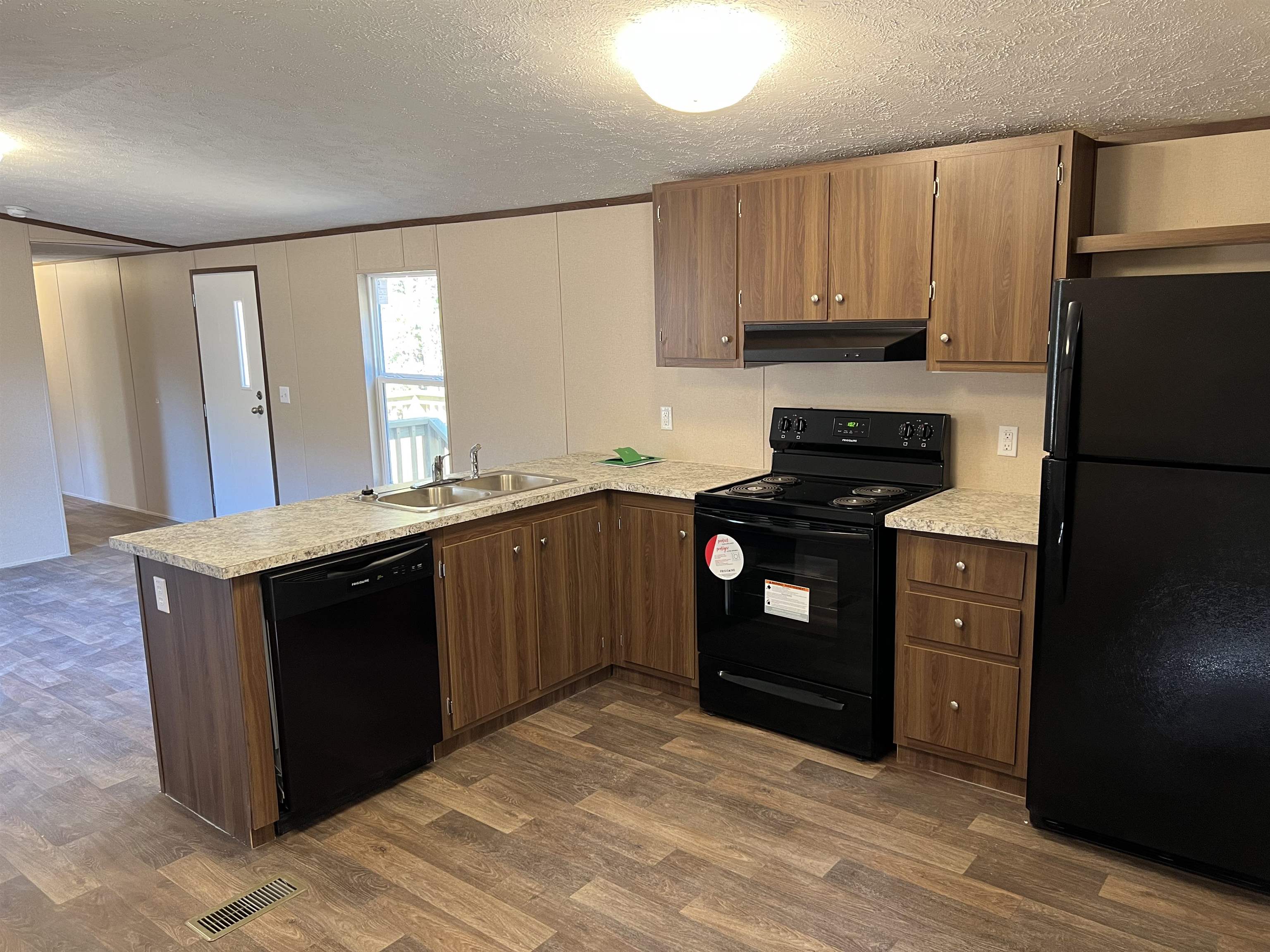 3390 Clifton Road Savannah, TN 38372 - Photo 3 of 12 a kitchen with a refrigerator stove and sink