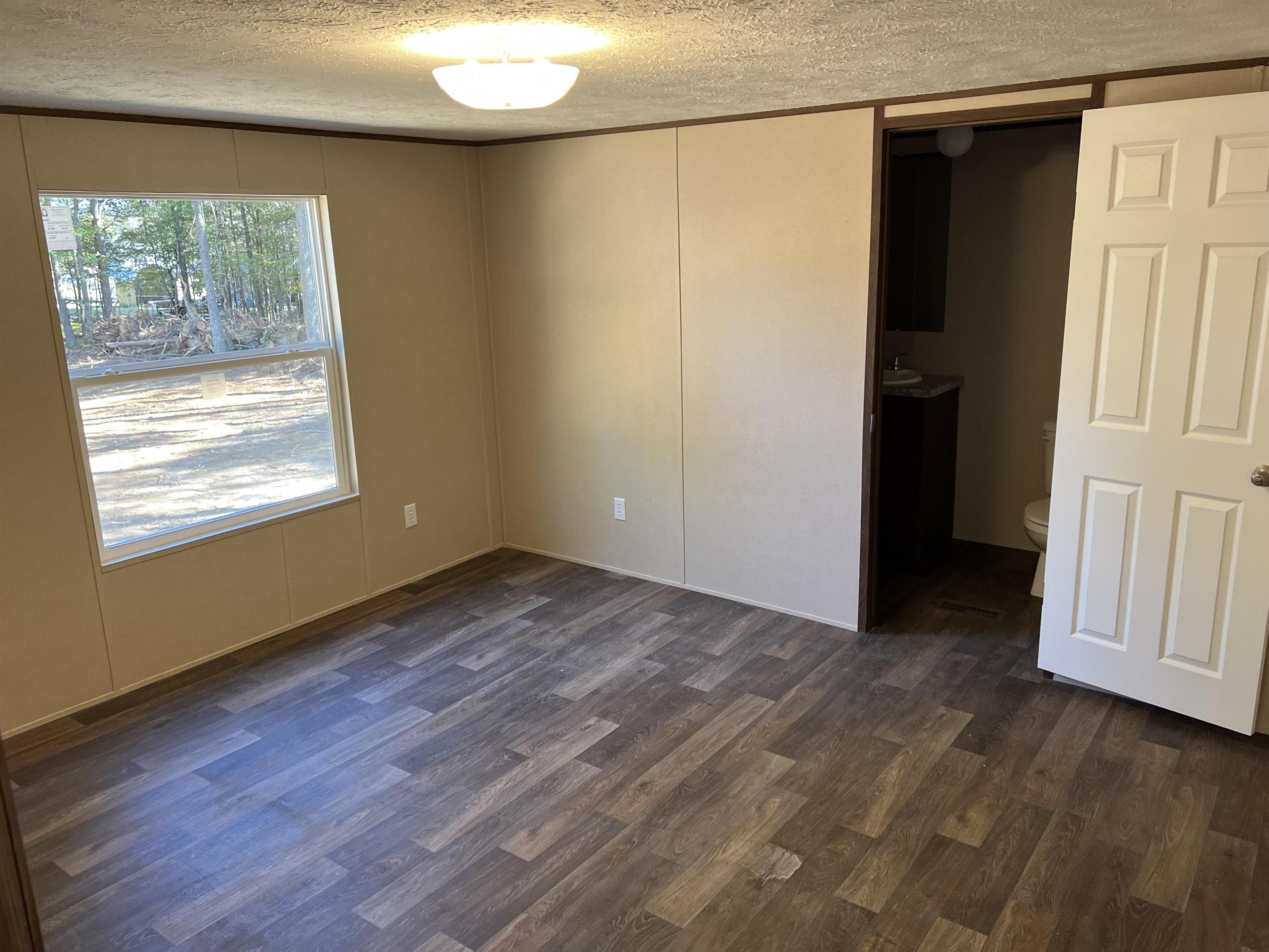 3390 Clifton Road Savannah, TN 38372 - Photo 6 of 12 an empty room with wooden floor and windows