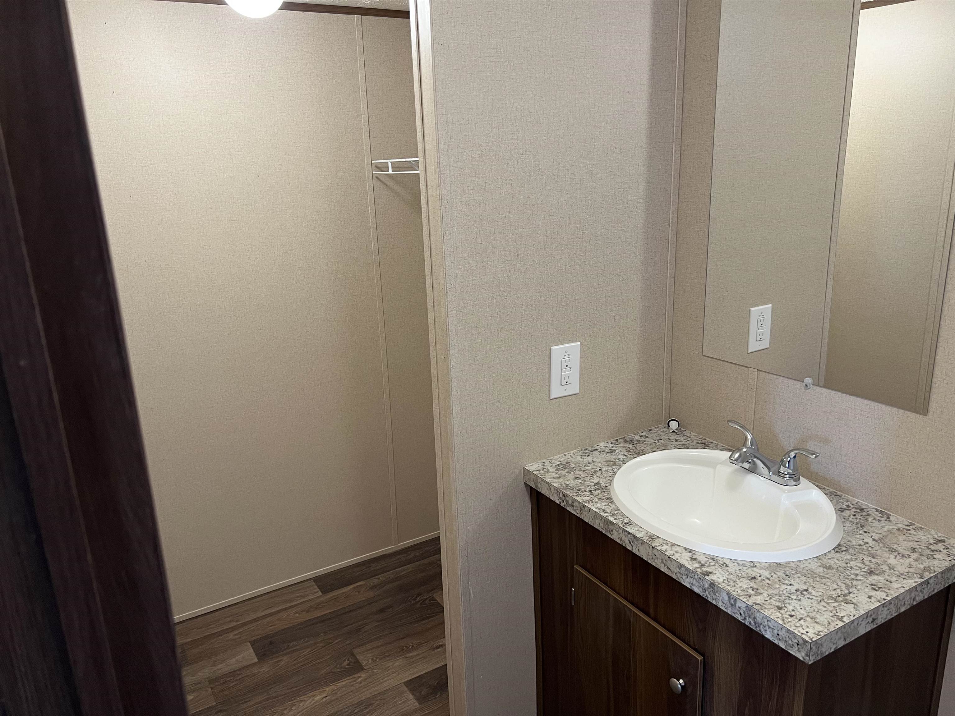 3390 Clifton Road Savannah, TN 38372 - Photo 8 of 12 a bathroom with a granite countertop sink and a mirror