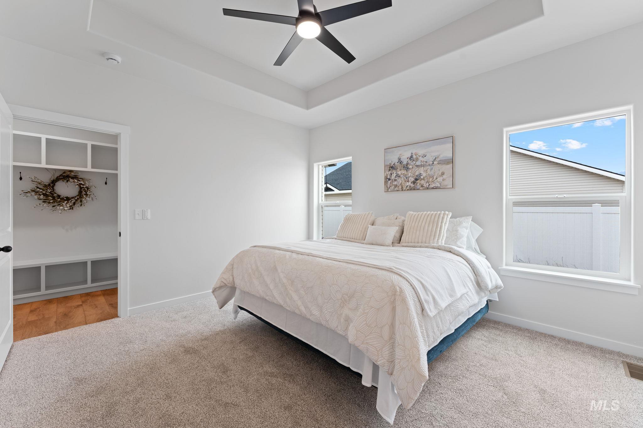 2220 Great Basin Way Burley, ID 83318 - Photo 20 of 39 Bedroom featuring a raised ceiling, light carpet, and ceiling fan