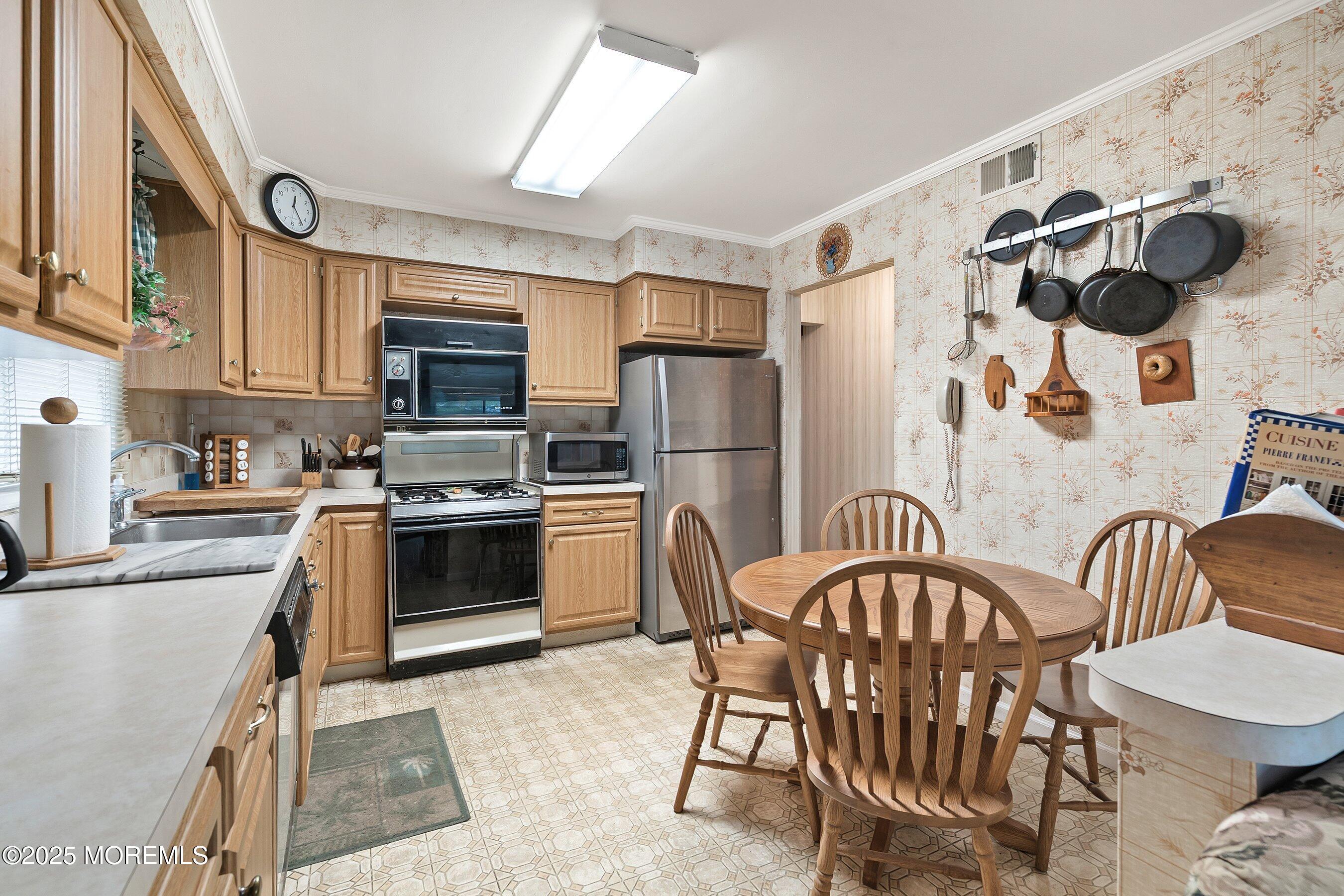 4 Olympus Way Brick, NJ 08724 - Photo 11 of 31 a kitchen with stainless steel appliances a refrigerator and a dining table