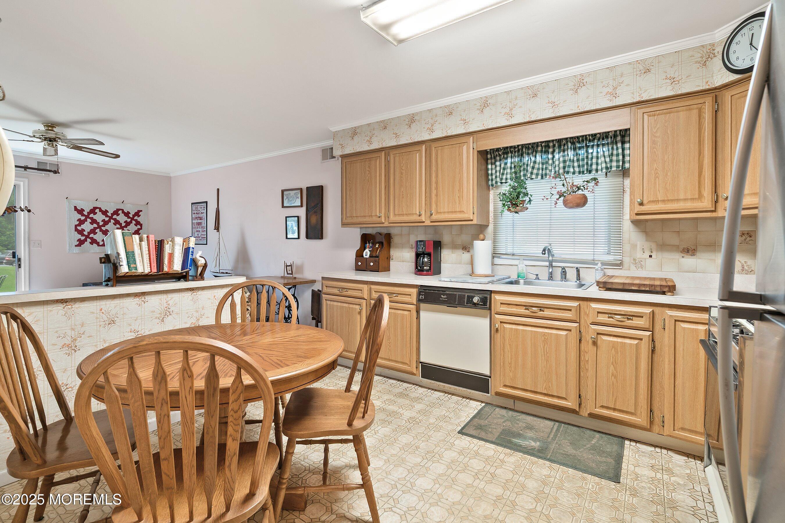 4 Olympus Way Brick, NJ 08724 - Photo 12 of 31 a kitchen with stainless steel appliances granite countertop a table chairs sink and window