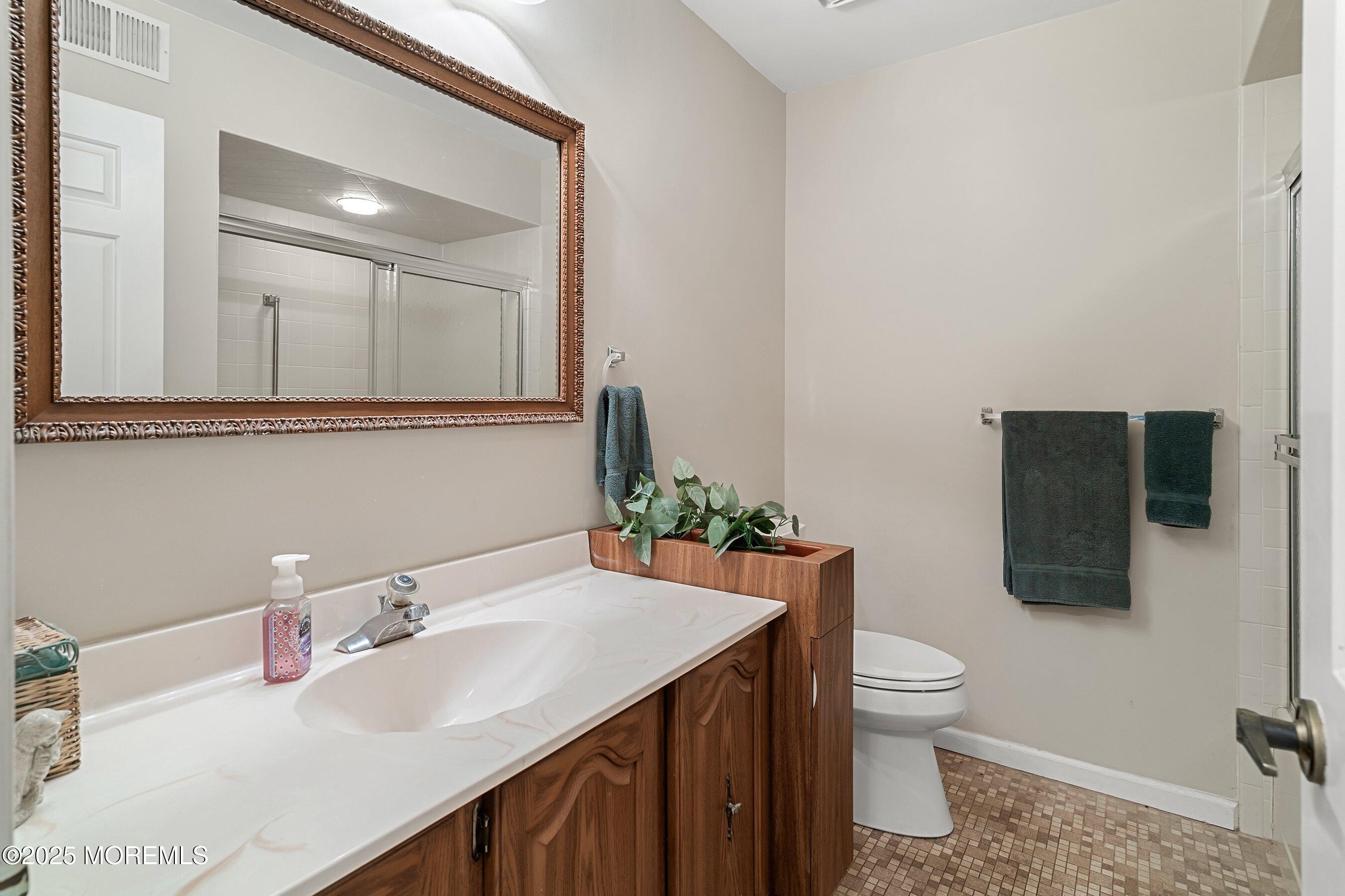 4 Olympus Way Brick, NJ 08724 - Photo 18 of 31 a bathroom with a sink toilet and mirror