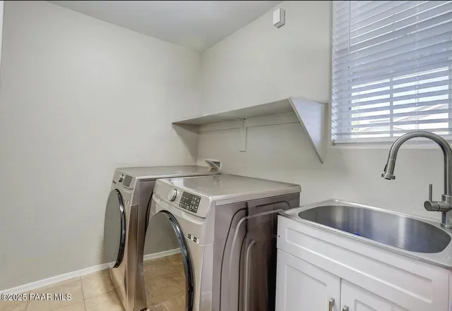a kitchen with granite countertop stainless steel appliances a counter space cabinets and a sink