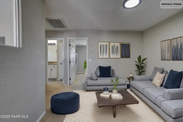 a bathroom with a granite countertop double vanity sink and a mirror