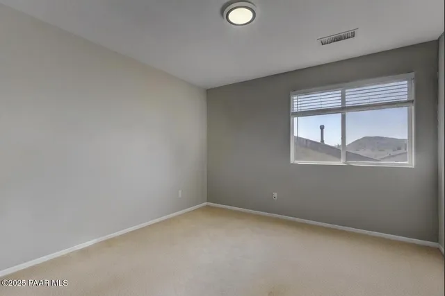 a bedroom with bed and window