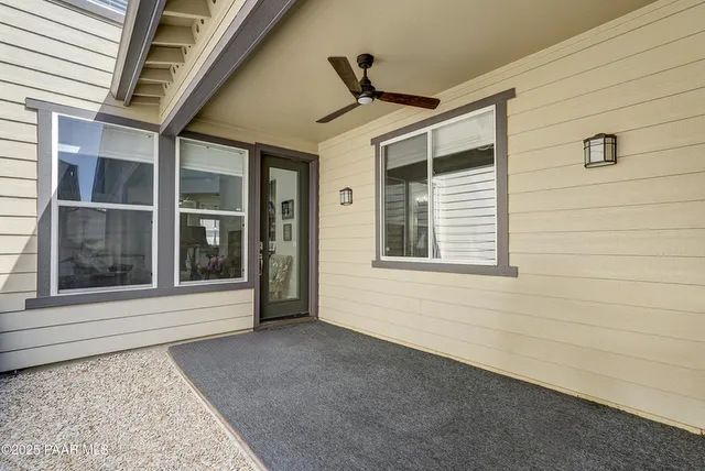 a view of a patio with couches and a potted plant on a table
